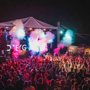 Lively outdoor music festival with vibrant lights, crowd energy, and a dynamic performance.